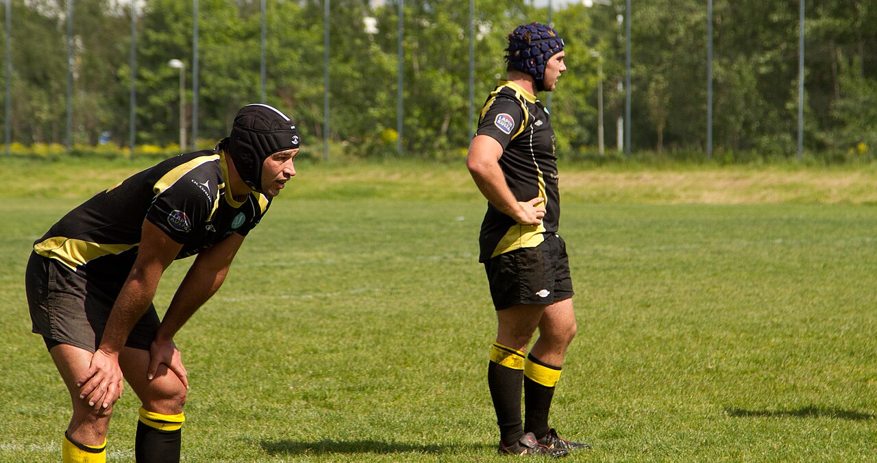 Rugby players in scrum caps during a match